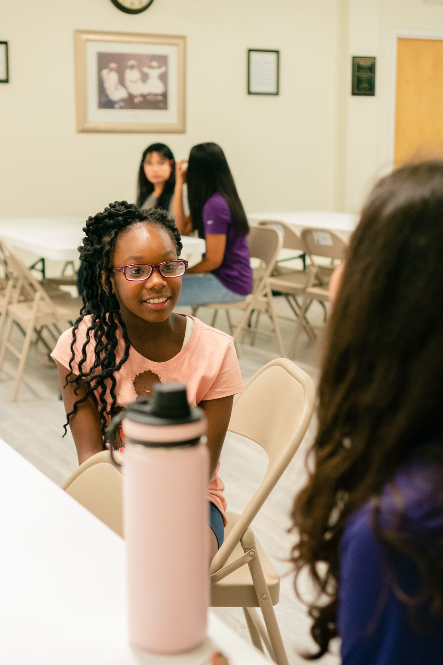 A girl talks with a college leader at the community writing center.