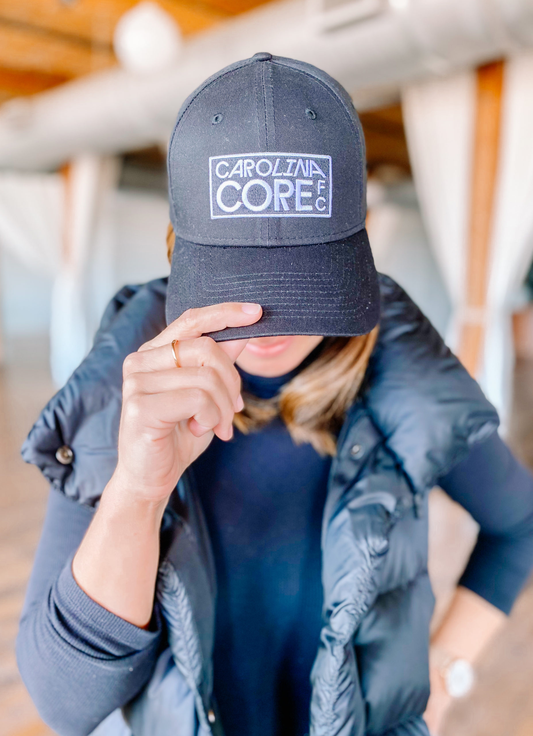 Megan Oglesby models a Carolina Core FC hat.