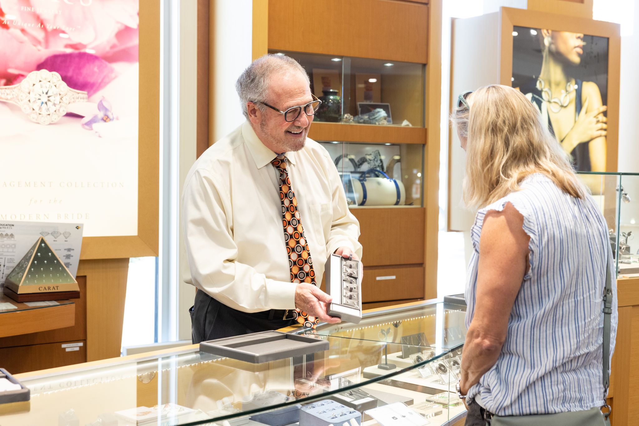 Gary Simon, owner of Simon Jewelers, shows a customer a product in his jewelry store.