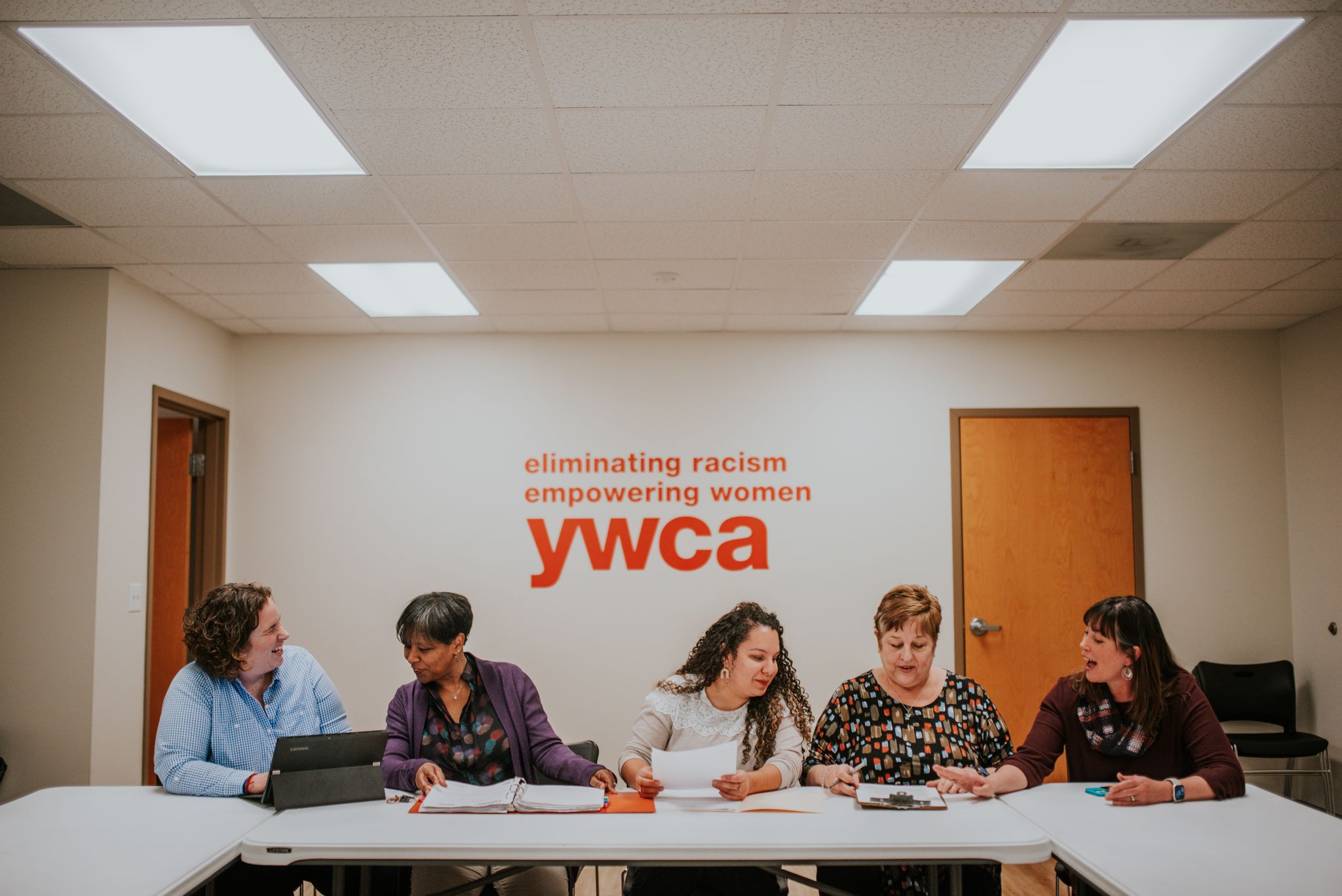 The directors at the YWCA High Point sit working together.
