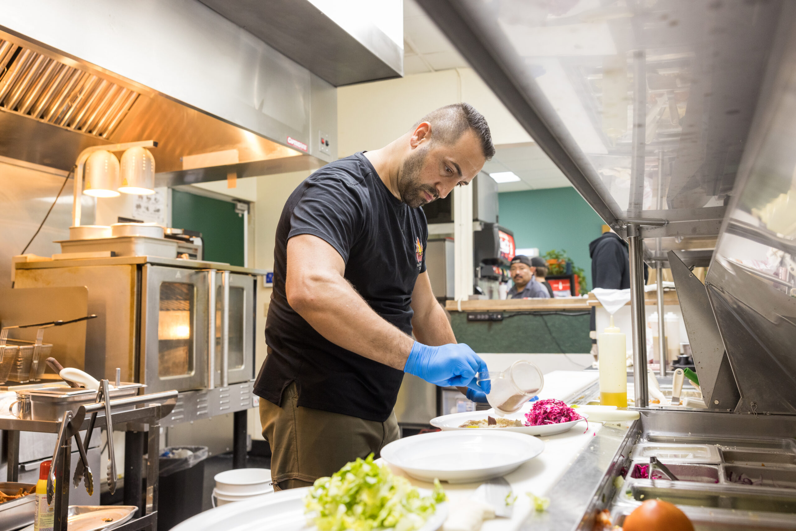 Odeh works on cooking a dish at his High Point restaurant, Odeh's Mediterranean Kitchen.