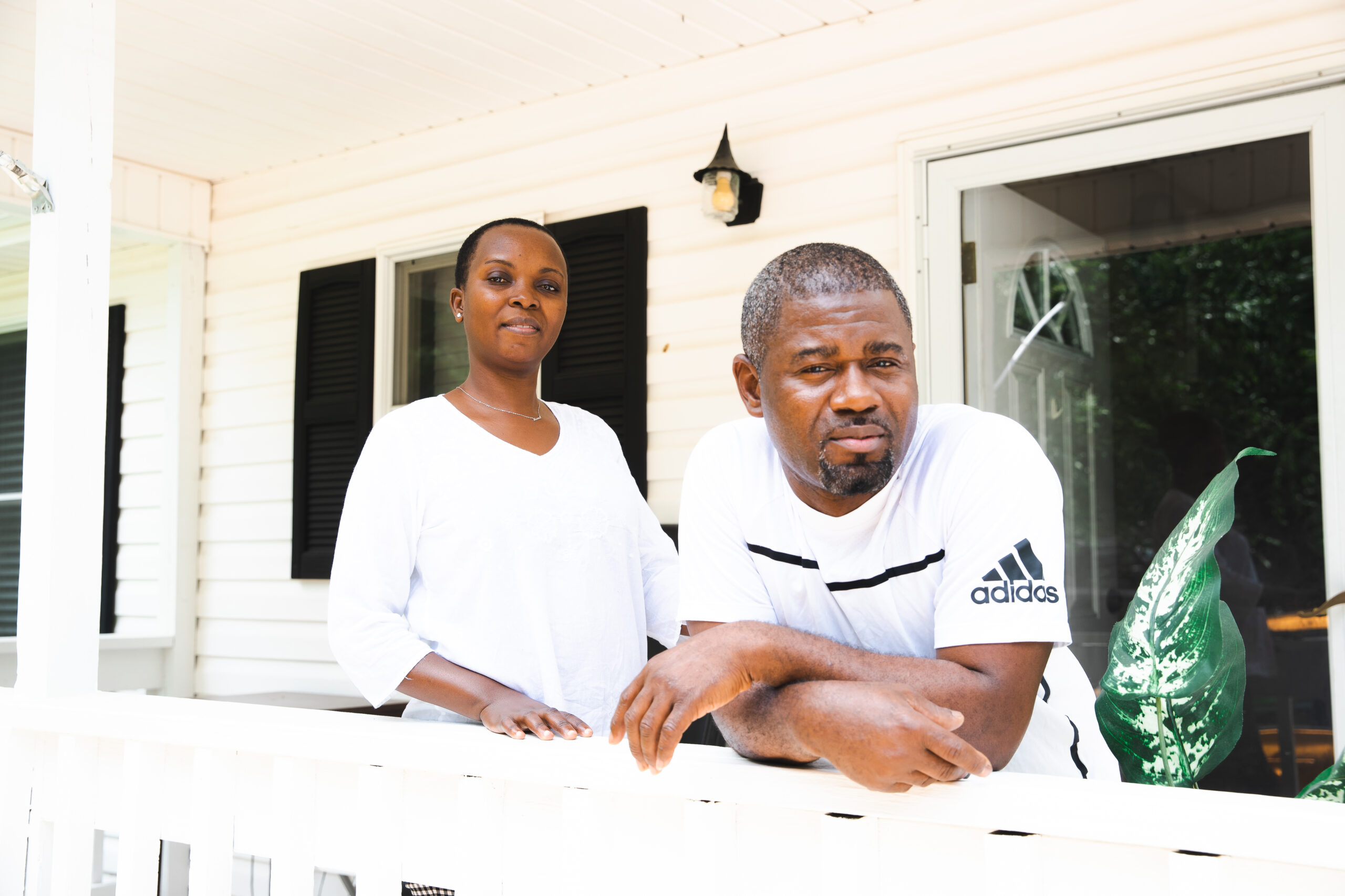 Didi and Ramazani Lwamba, refugees and clients of World Relief of the Triad stand on their porch.