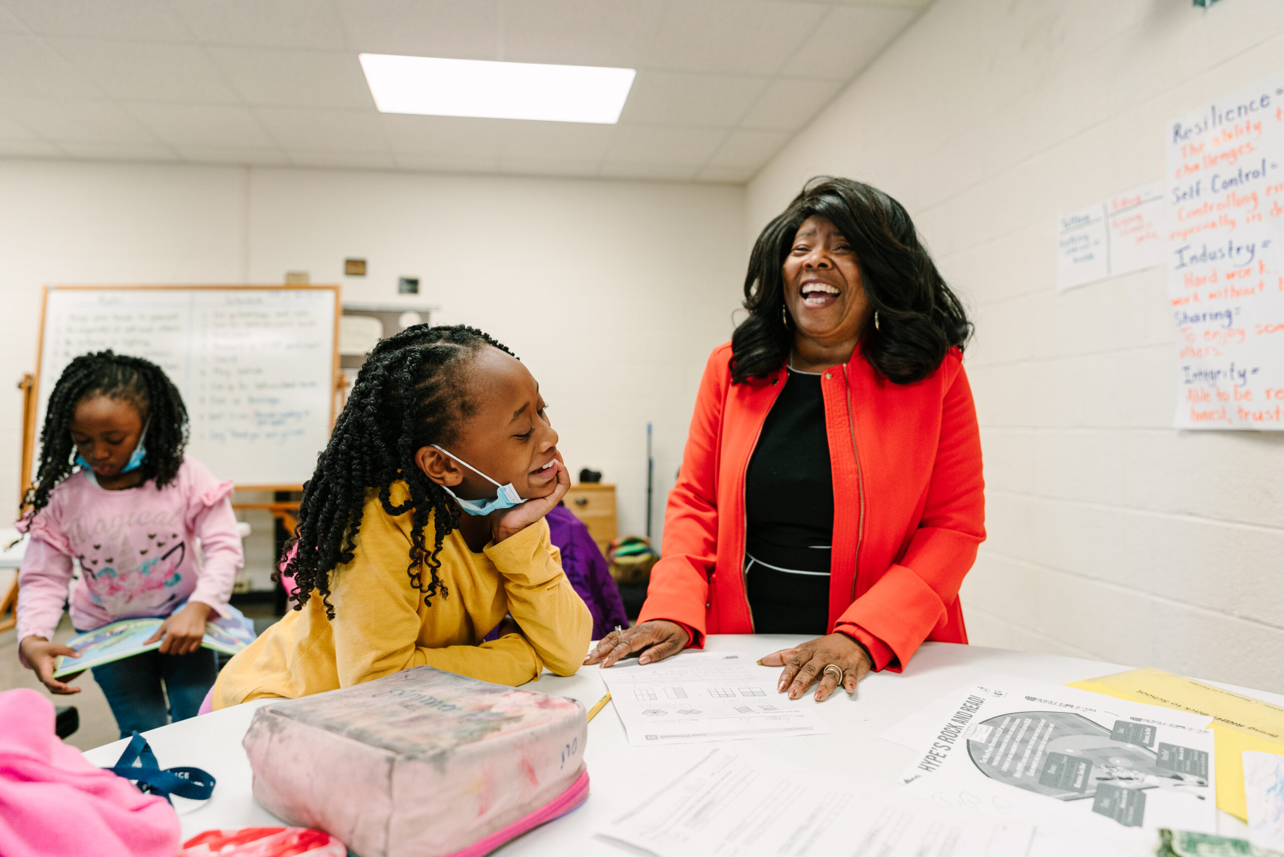Dr. Claire Robinson laughs while she works with a student at LEAP in High Point, NC.