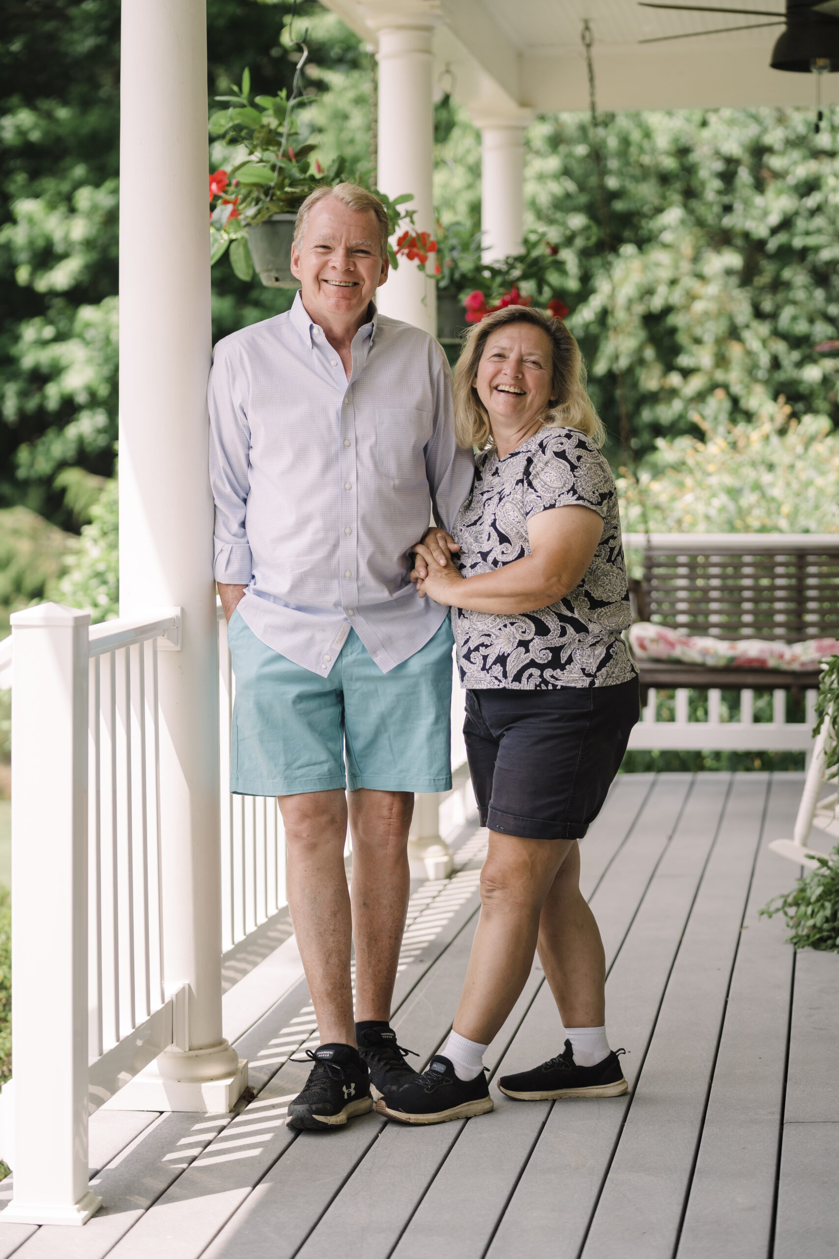 Ron & Jenny Barker, Owners of Seven Oaks Bed & Breakfast stand on their porch in High Point, NC.