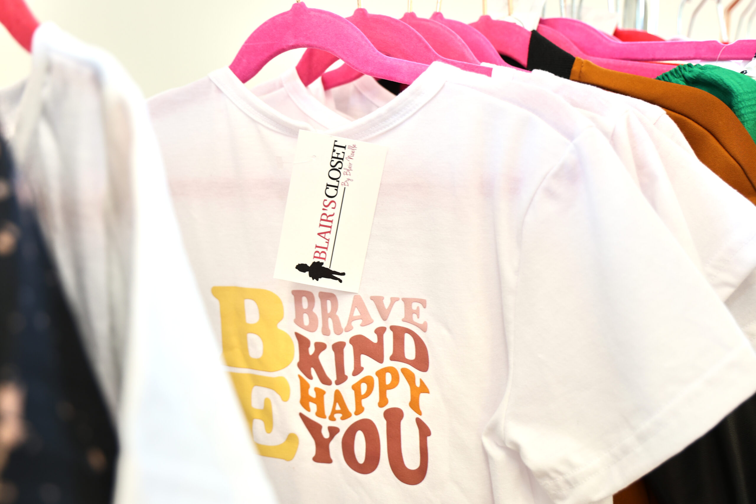 A shirt from I Am Blair's Closet that says, "Be Brave, Kind, Happy, You."