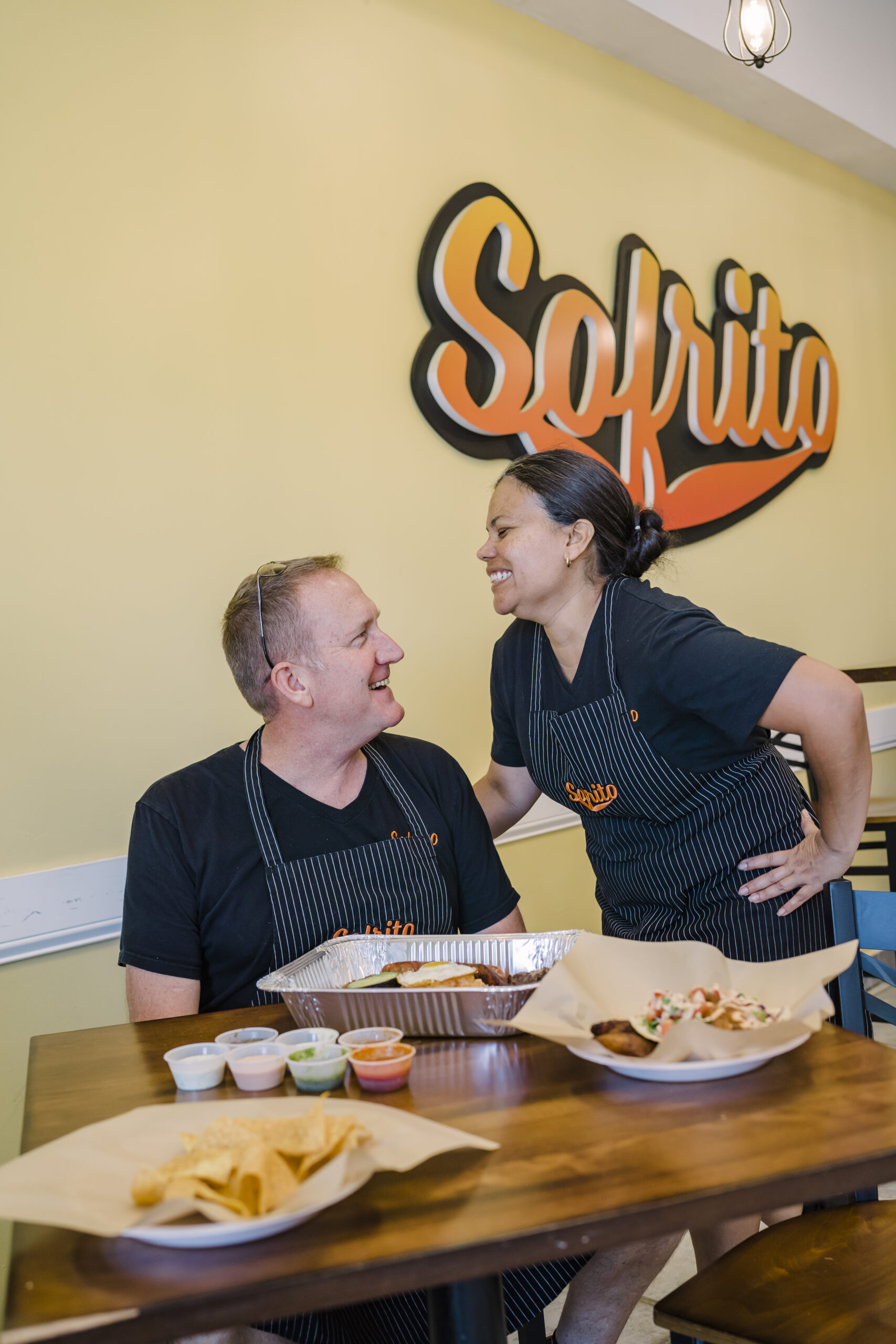 Steve and Angelica White laugh together at their restaurant in High Point, NC – Sofrito Latin street food.