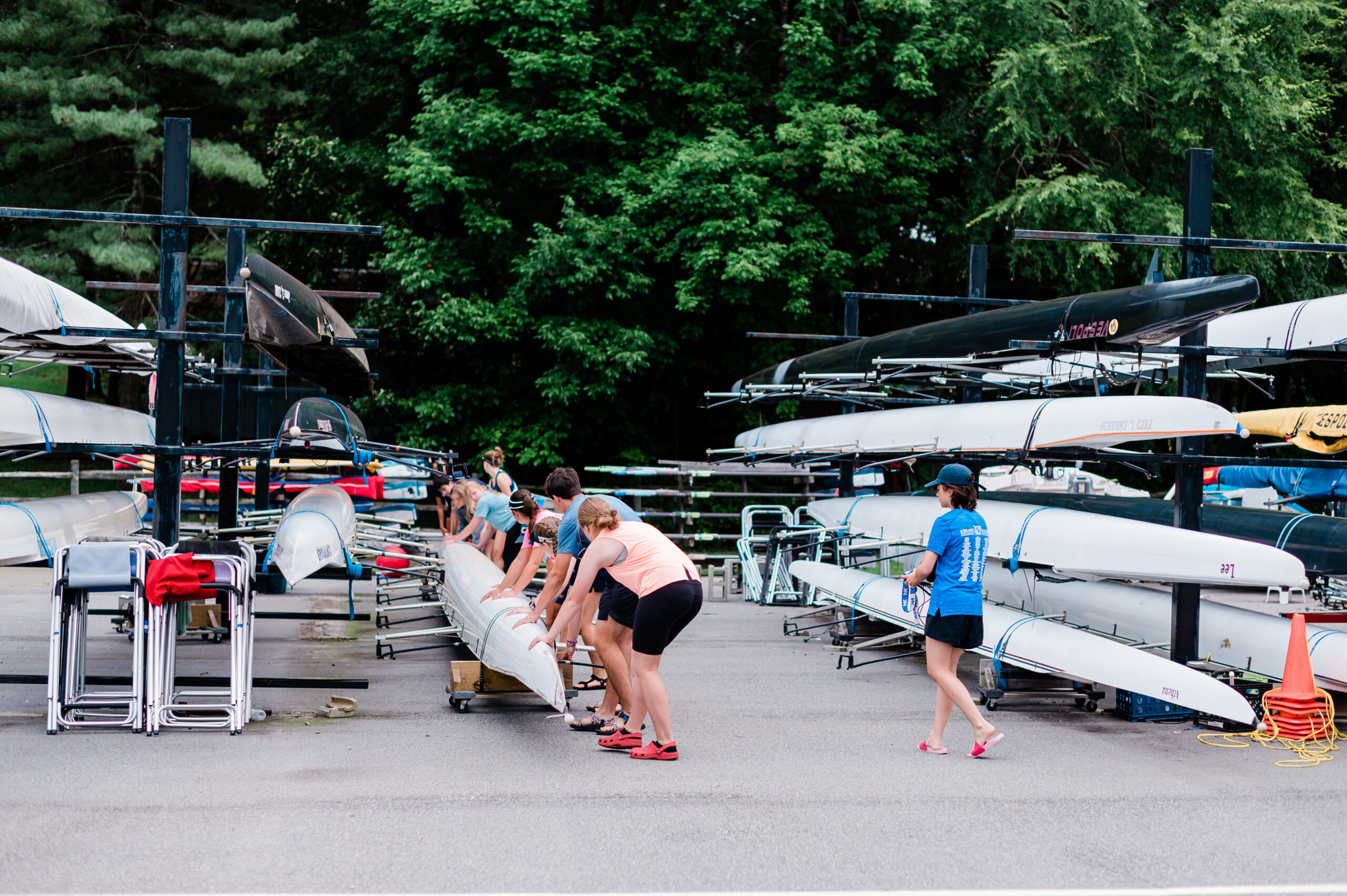 A crew team of rowers in High Point, NC pick up a boat to move it to the lake.