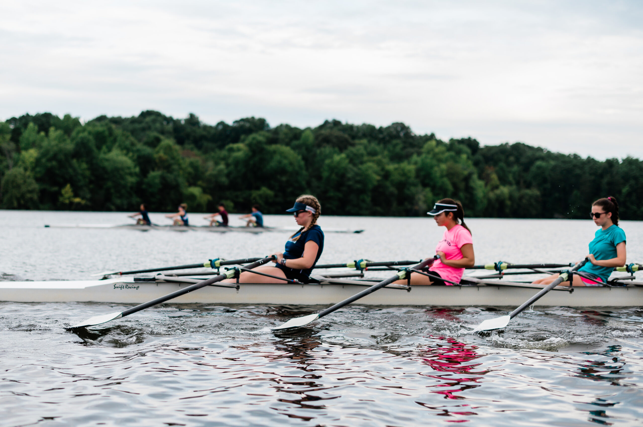 Teams row across Oak Hollow Lake.