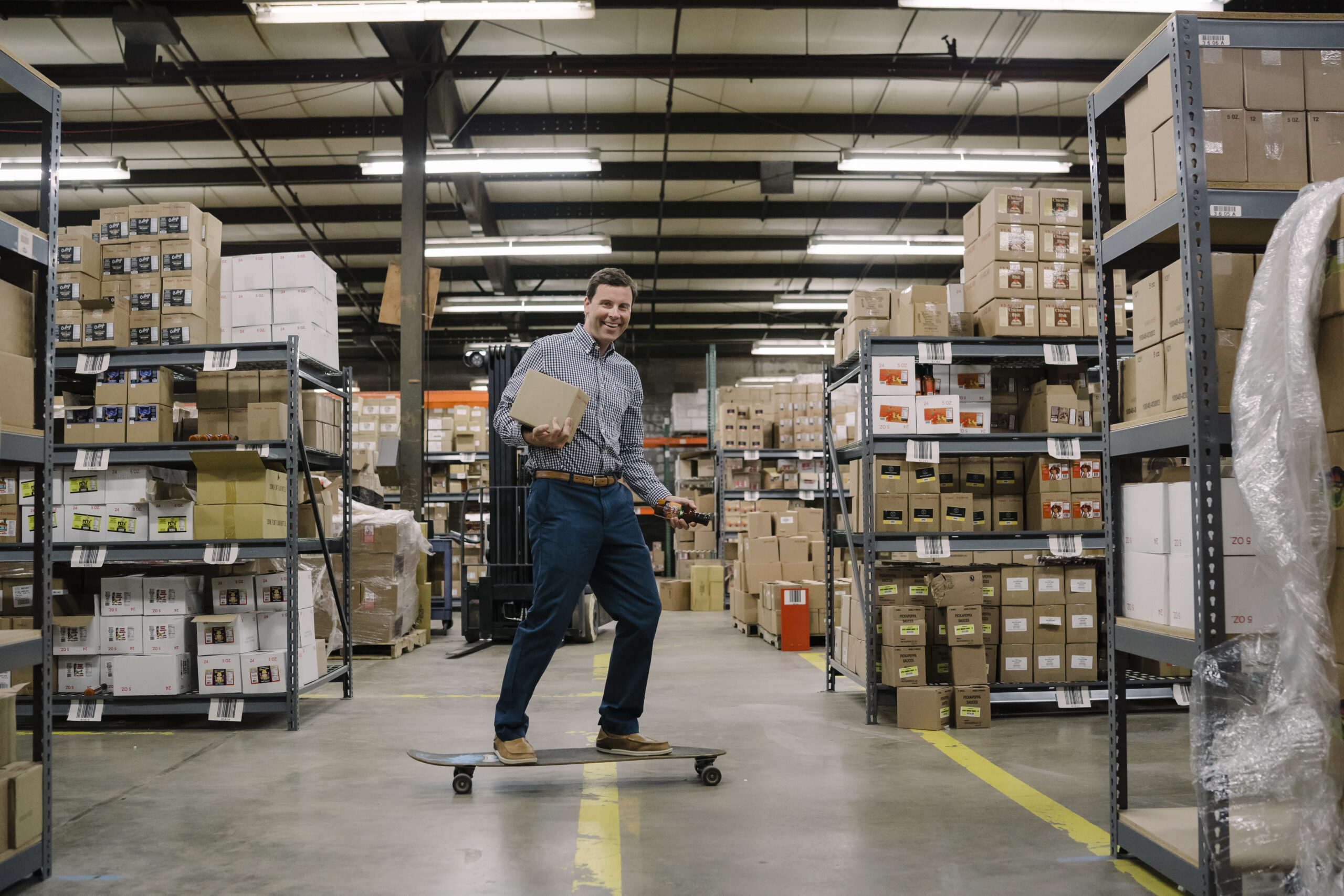 Matt Heald skateboards through the warehouse.