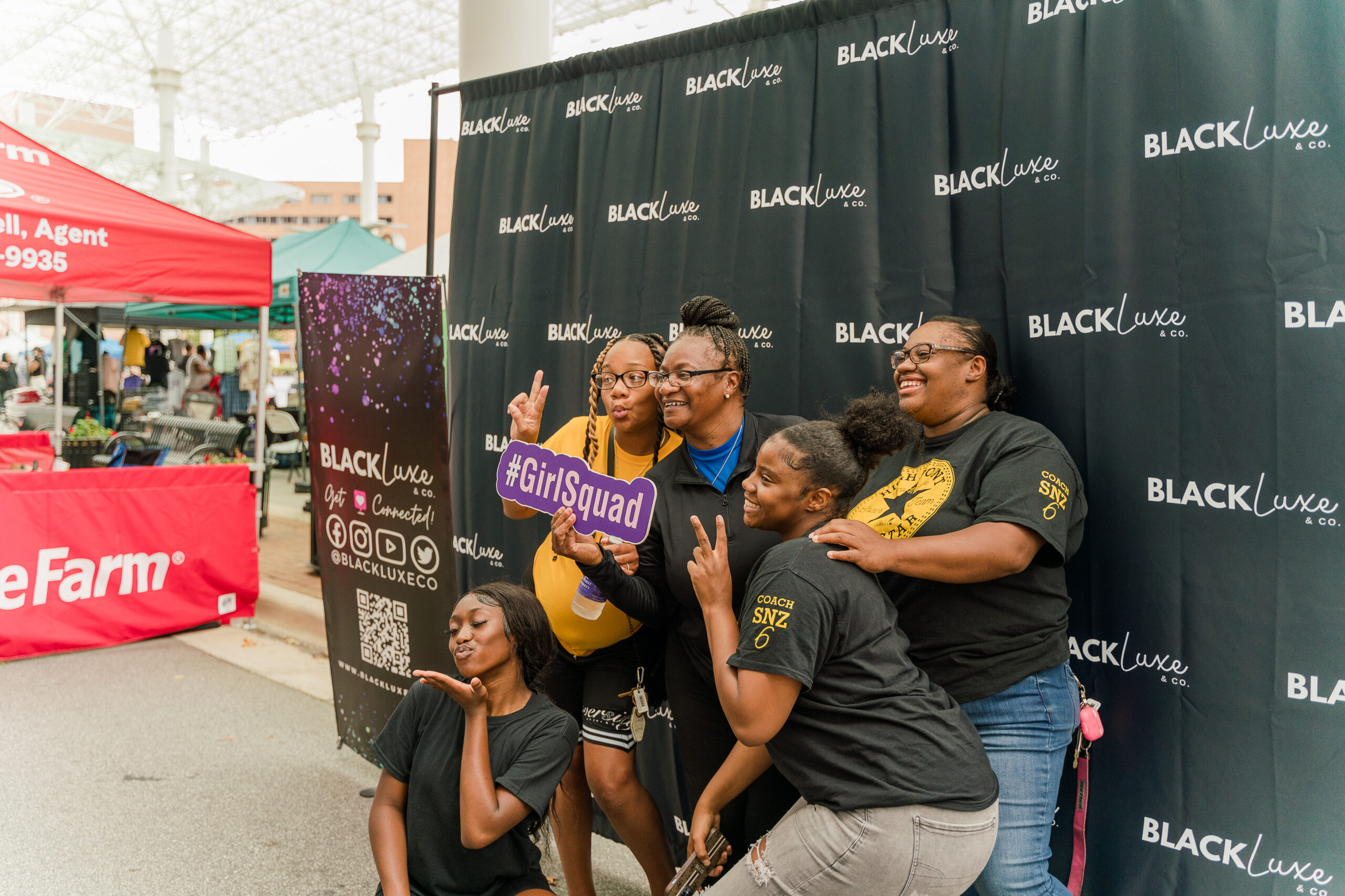 People posing for a picture at the Black Luxe Expo.