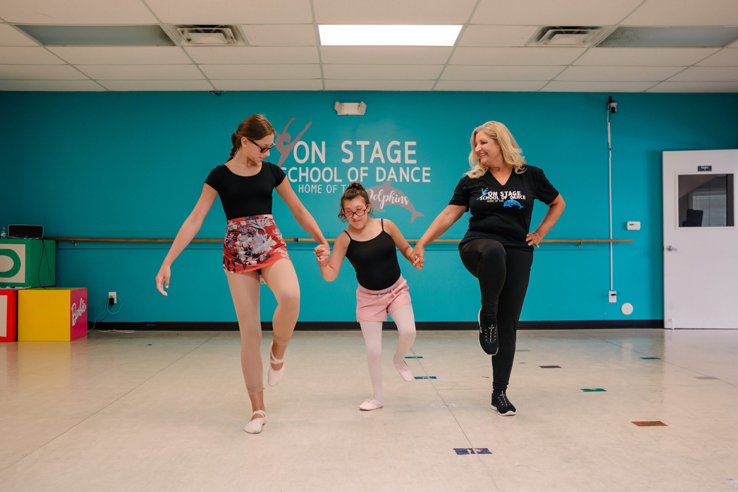 Lori dances with one of her Shining Star students, Kelsey at the On Stage School of Dance studio in High Point, NC.