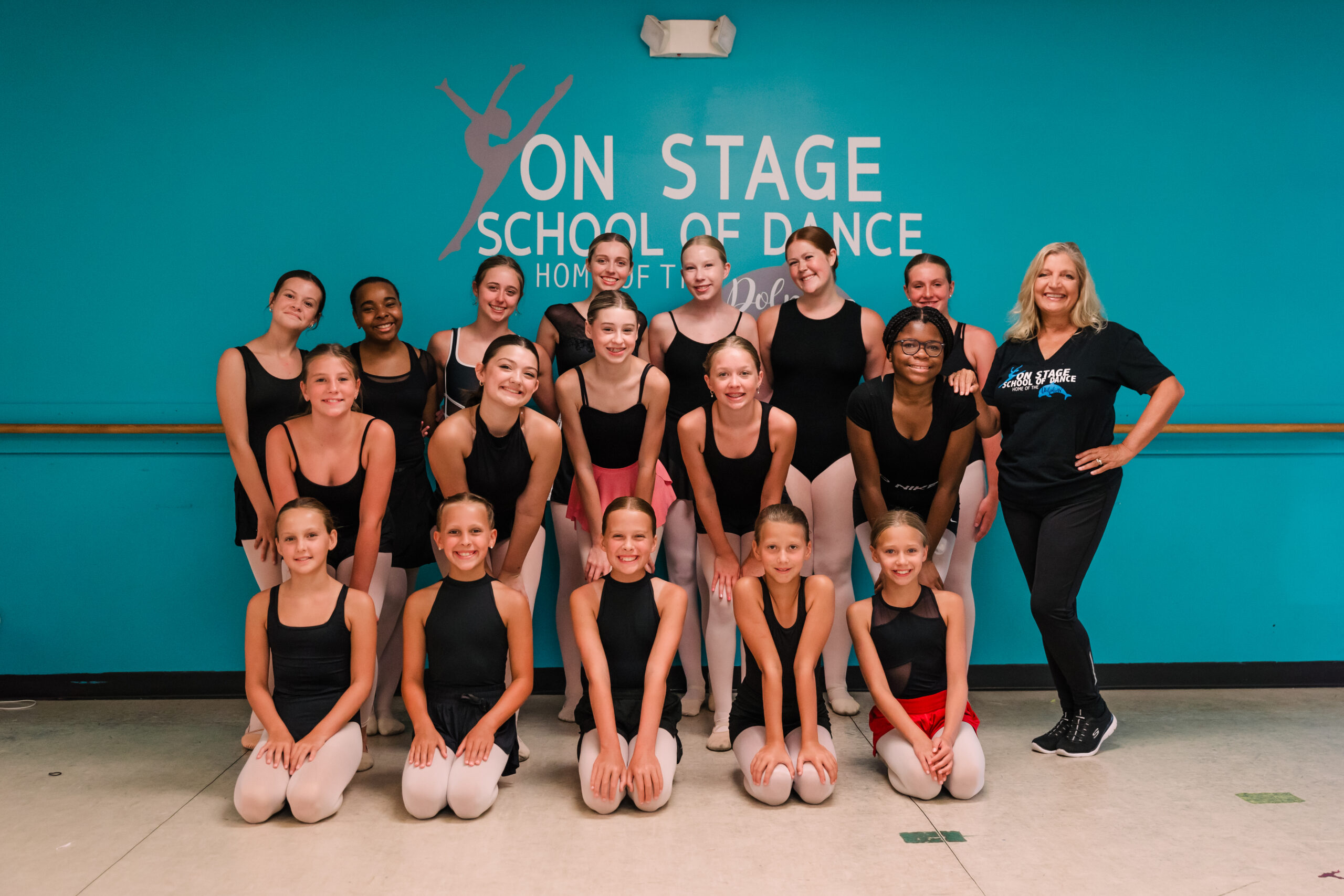 A group of dancers standing in their dance studio in High Point, NC.