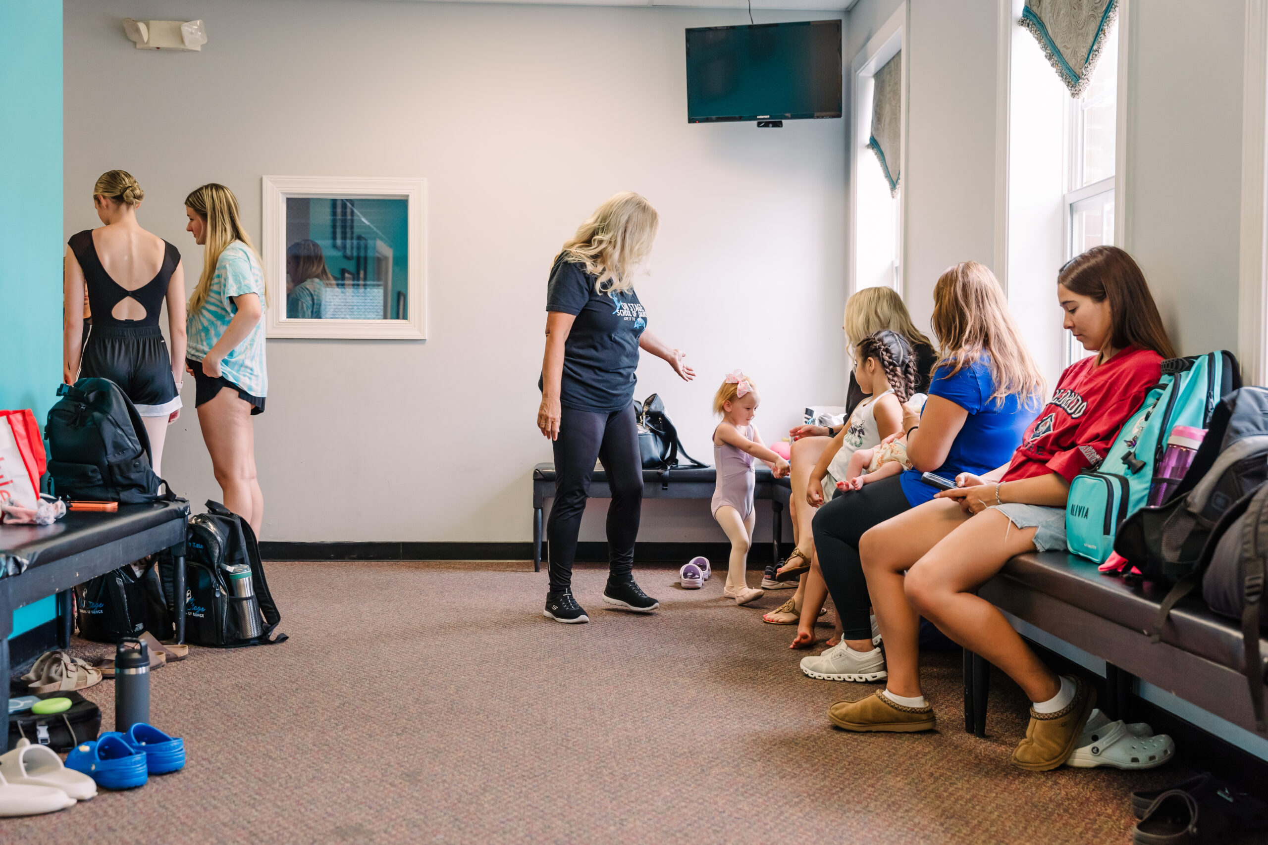 Dancers gather in the lobby area of the High Point dance studio, On Stage School of Dance.