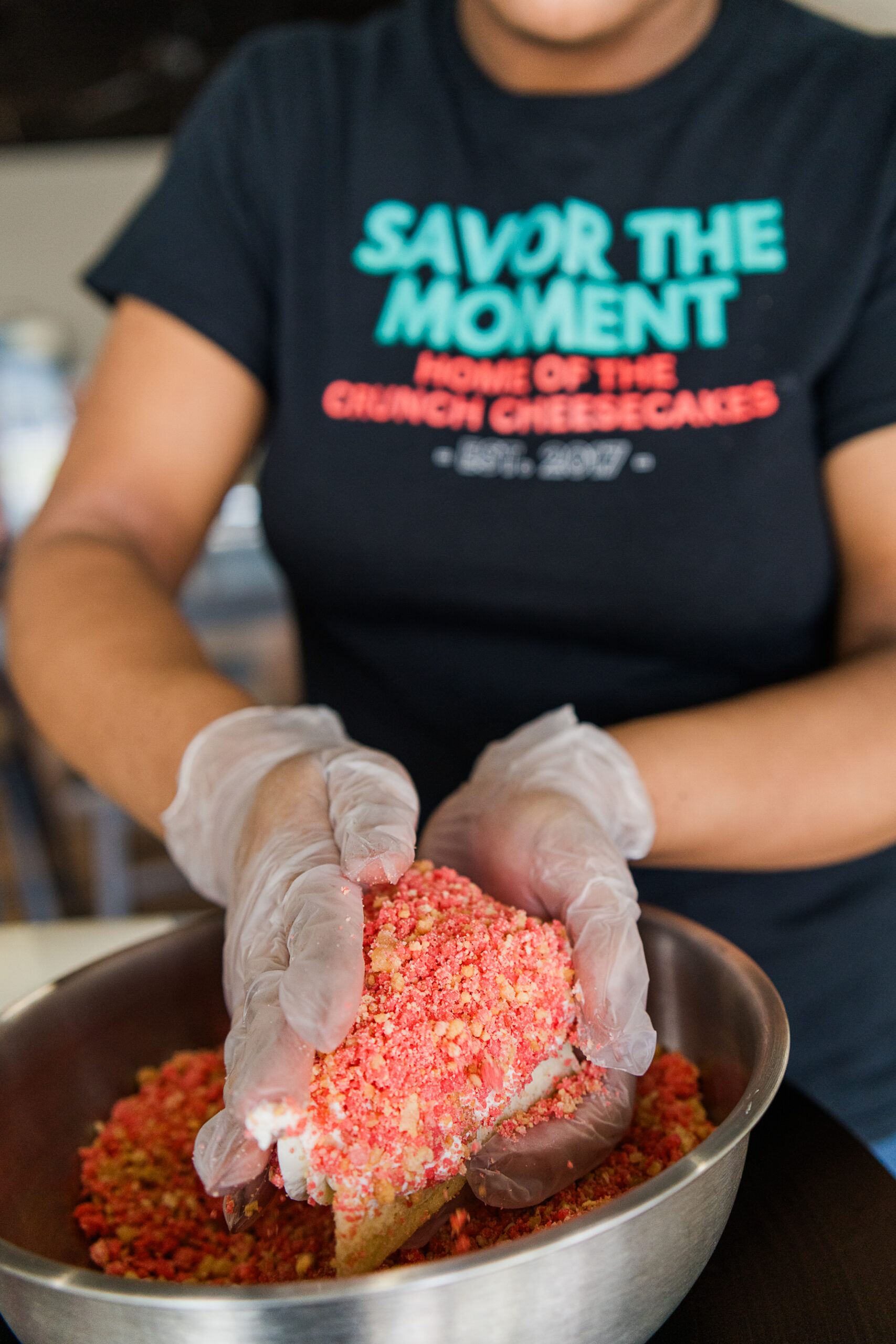 employee making Crunch Cheesecake at Savor the Moment in High Point, NC.