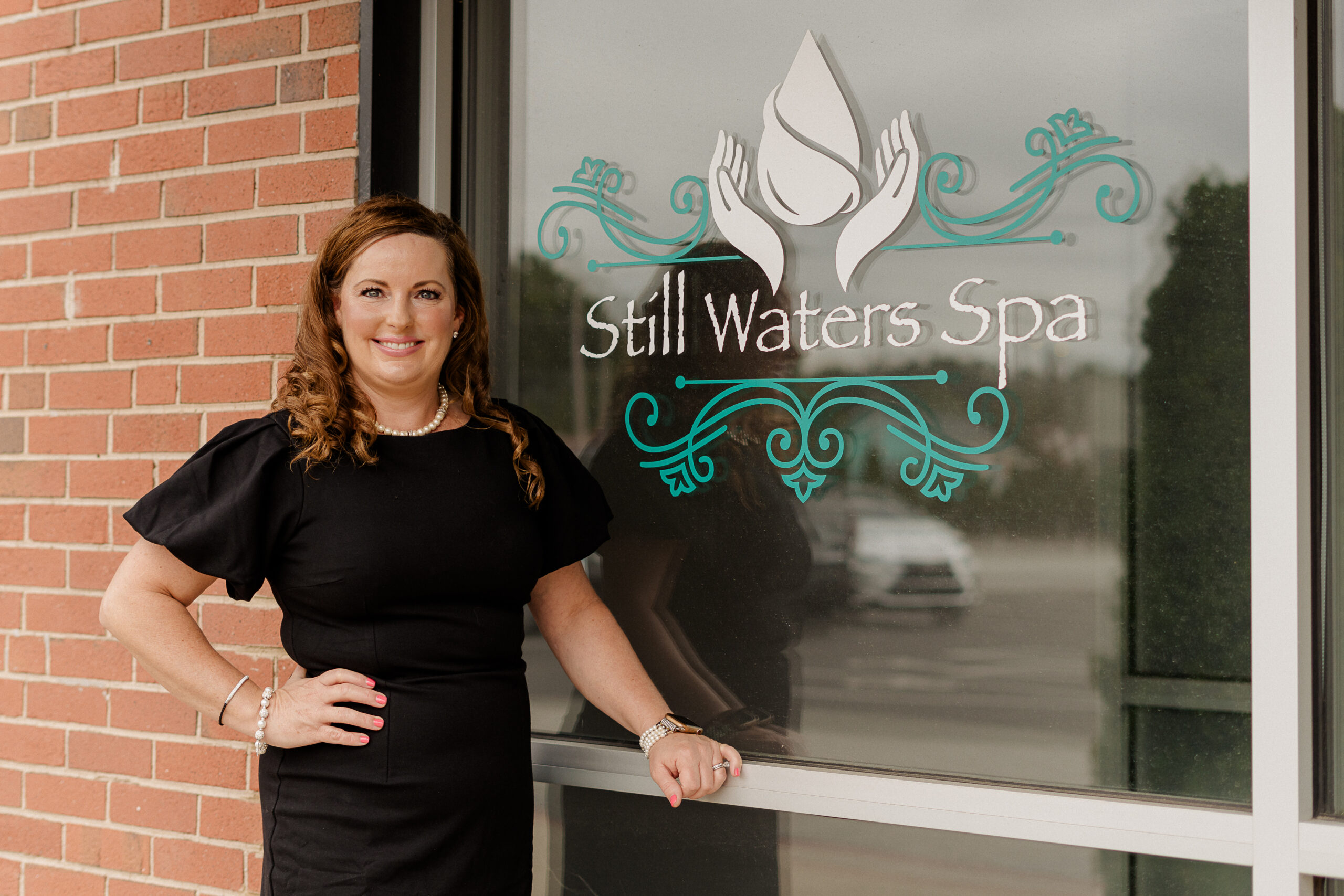 Tara Lackey poses for a picture in front of Still Waters Spa.