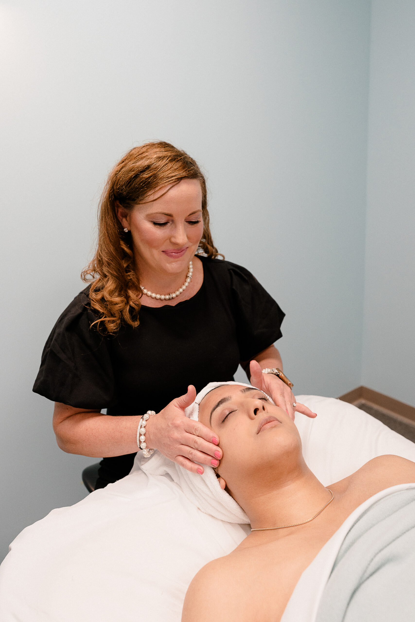 Tara Lackey massages a clients face